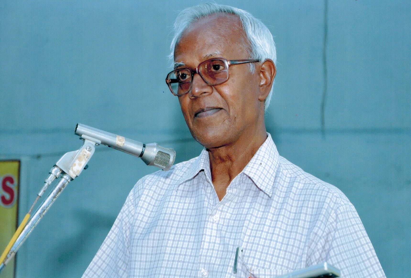 Fr Stan Swamy stands at a microphone