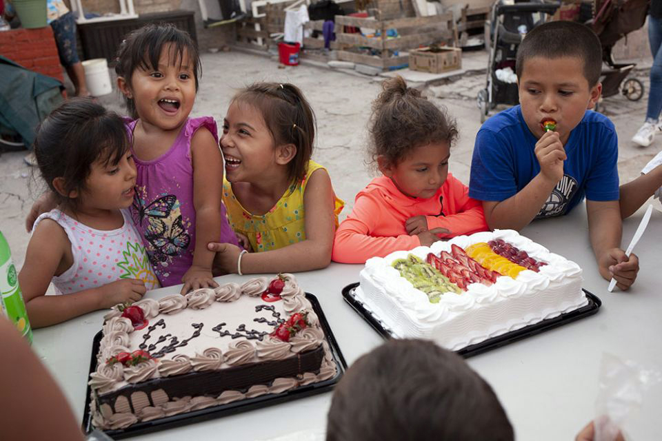 Birthday girl Ximena Lino Romero, 3, second from left, laughs with friends during a party for her and a friend at the El Buen Samaritano immigrant shelter.