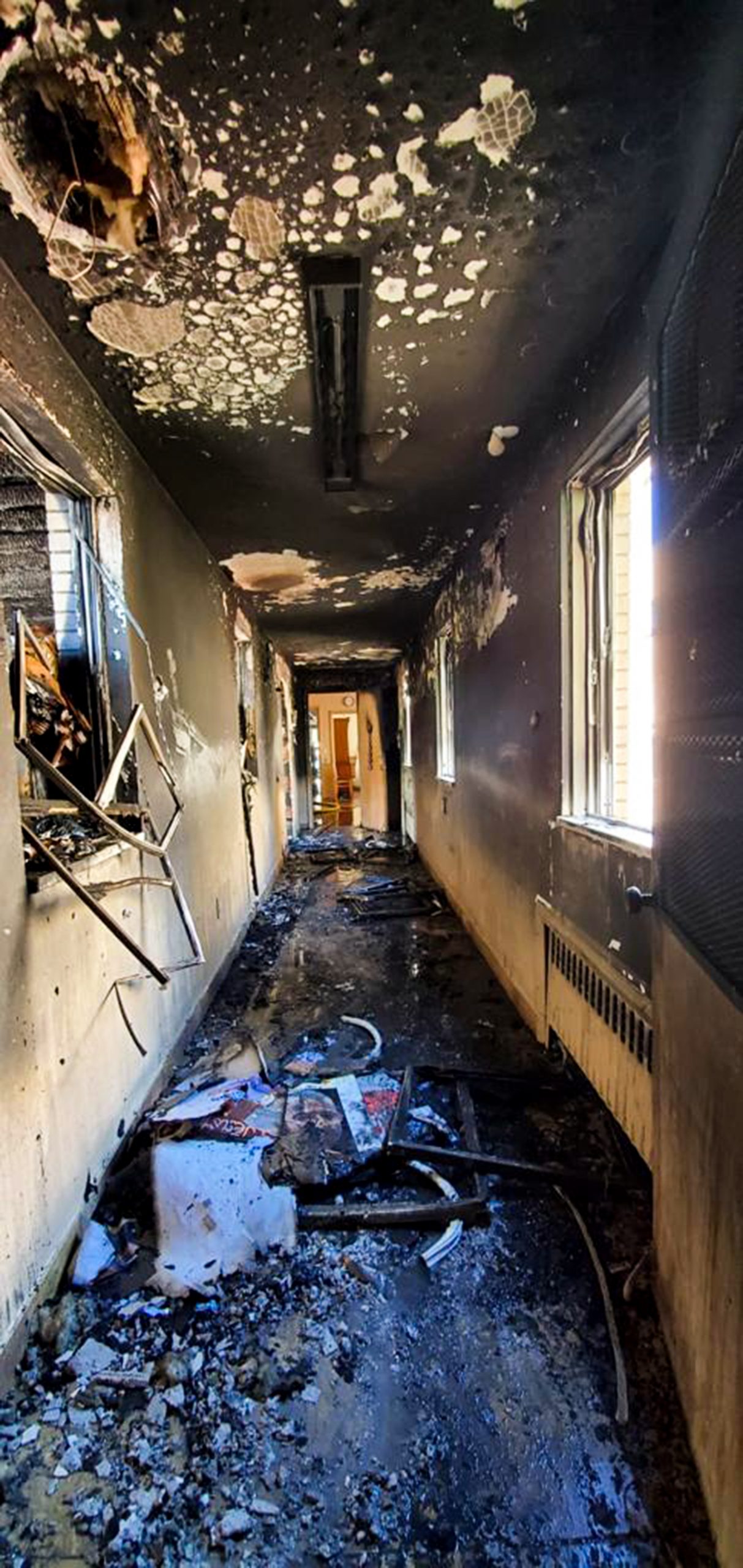 a hallway is burned and charred after a fire in the rectory
