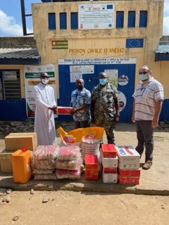 a Comboni priest delivers donations to a Togo prison