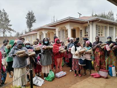 Mothers from Soweto, Kenya receive food rations from the feeding program.