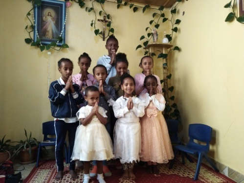 Children at the Good Samaritan Sisters orphanage pose with praying hands