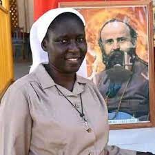 Sister Susan, Comboni missionary sister, stands in front of a painting of St. Daniel