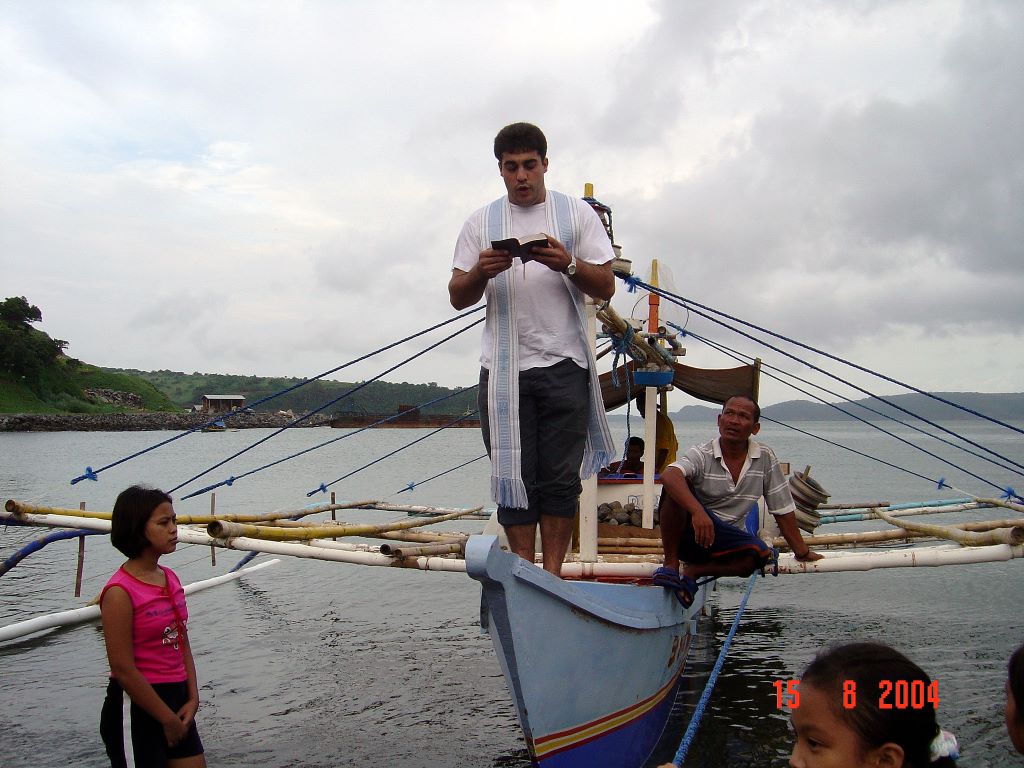 Fr David preaching from a boat